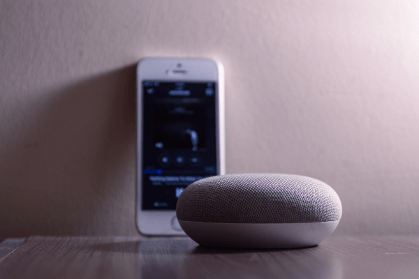 Grey Bluetooth speaker and a mobile cellphone