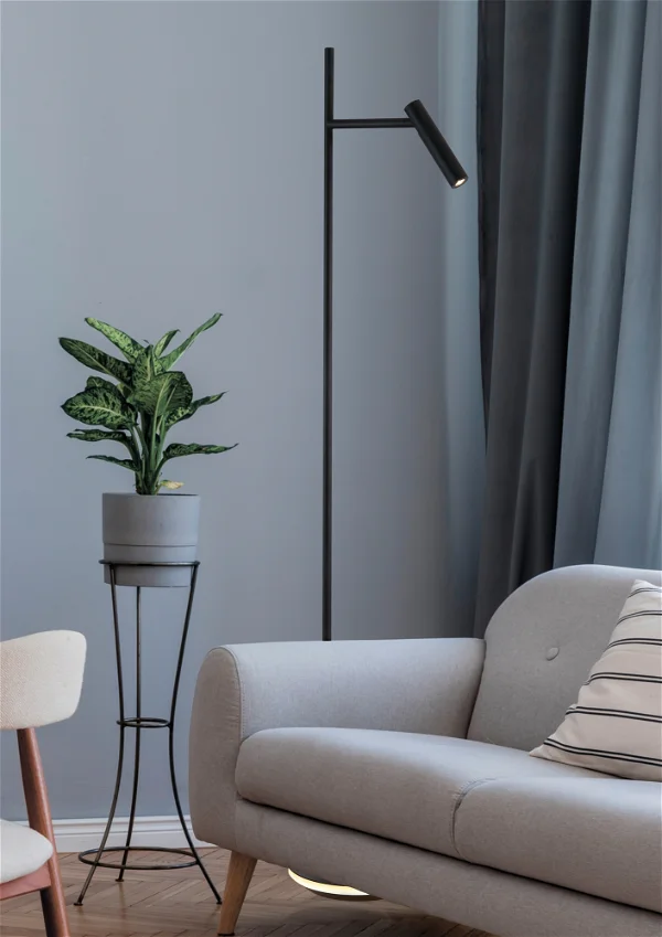 a floor lamp with a green plant on the side