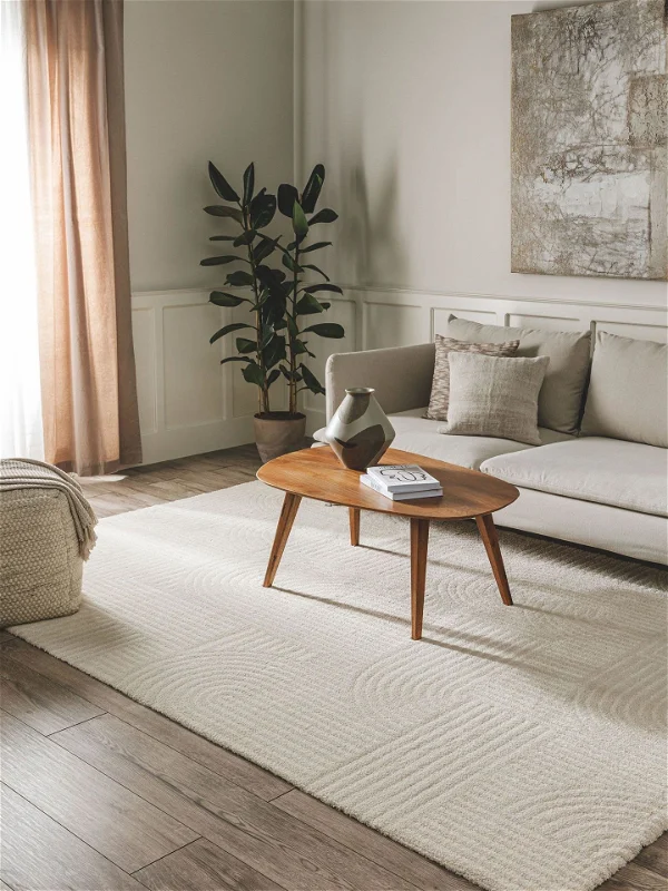 Sunlit living room with beige carpet and mid-century accents with wall art