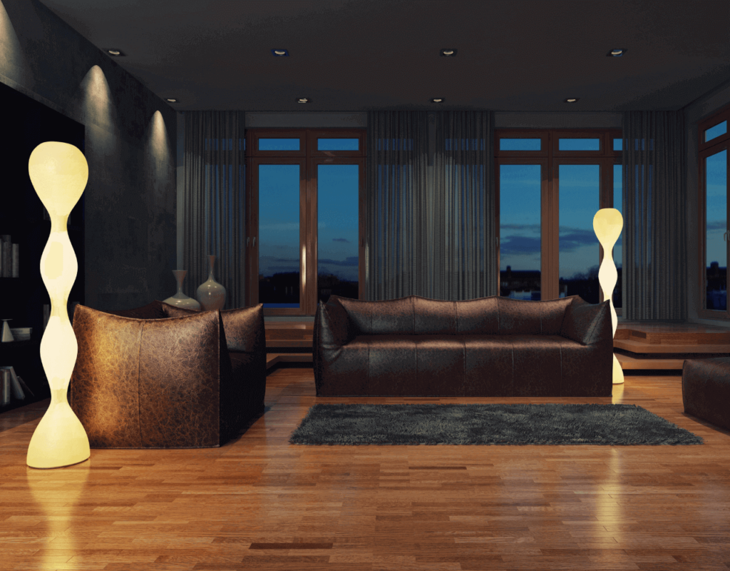 Modern living room with organically shaped floor lamps and brown leather sofas with views through large windows