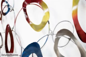 Wall installation of varied metallic and colored abstract loops.