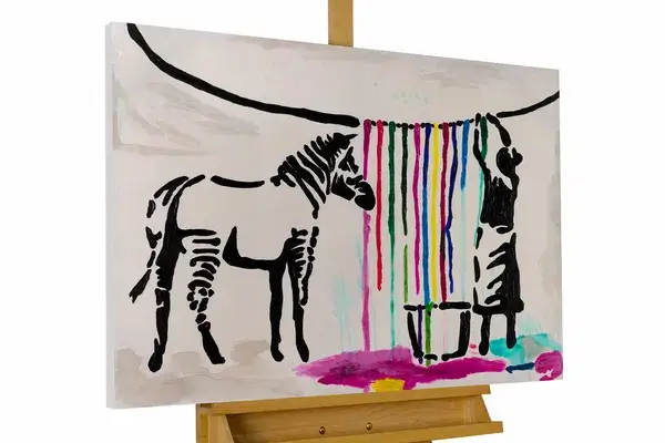 A landscape image of a zebra and a girl hanging a colorful ribbons