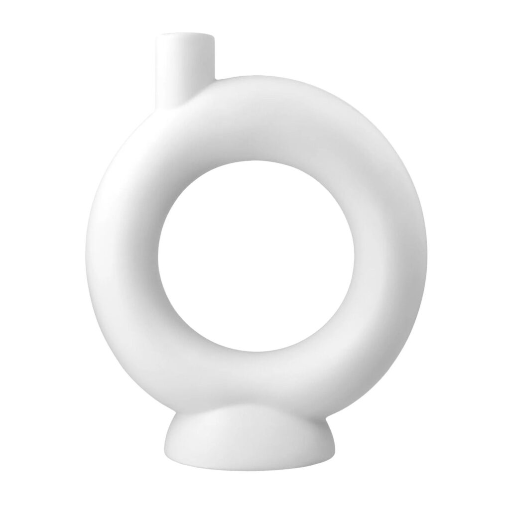 A contemporary matte white ceramic vase designed in a minimalist donut or circular hollow shape on a plain background.